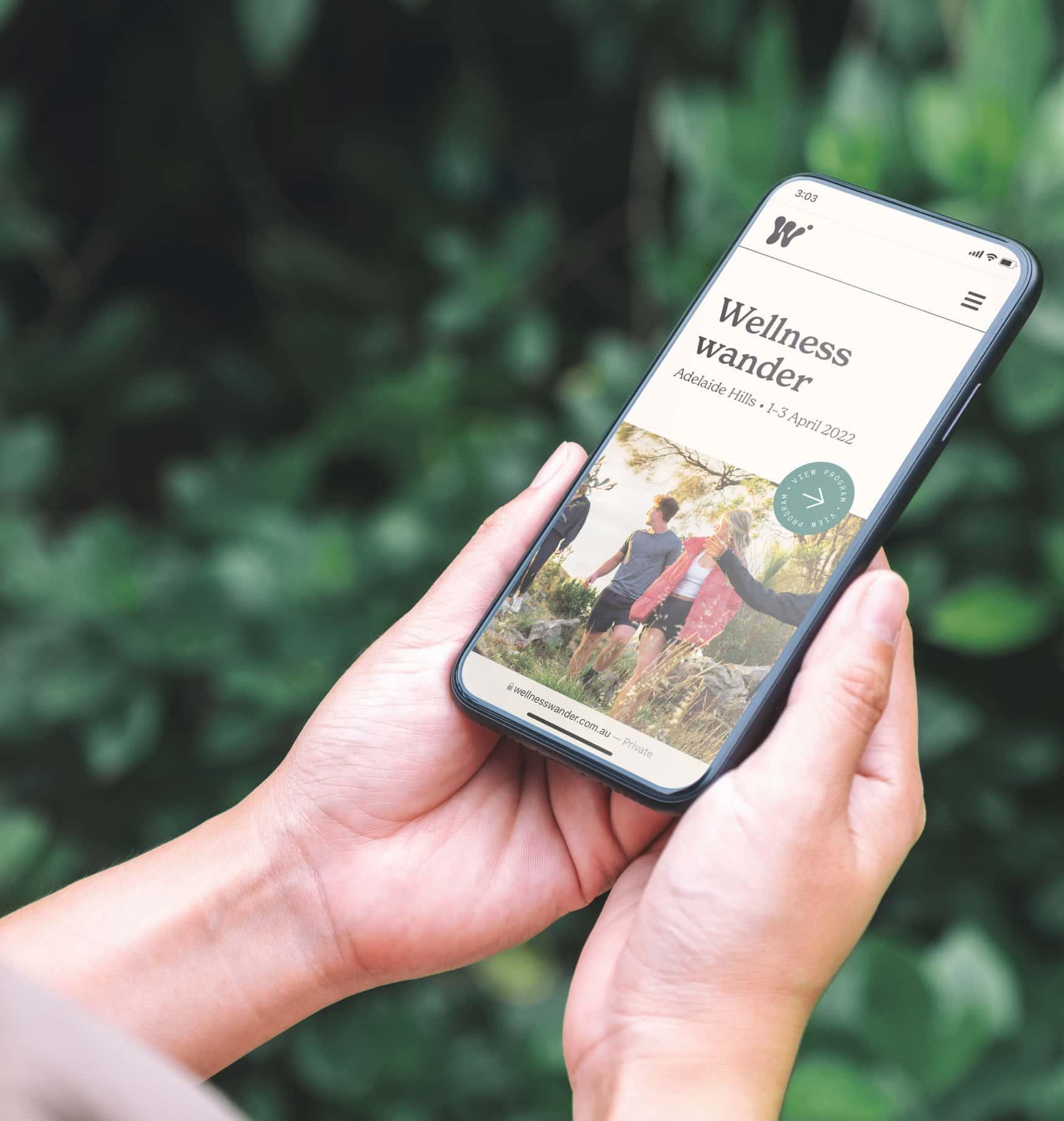A mockup of the Wellness Wander website on a mobile phone