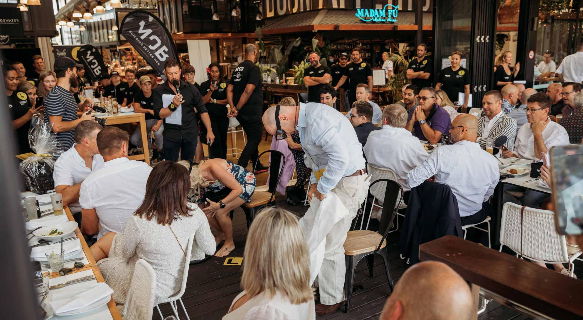 A large gathering of people having lunch